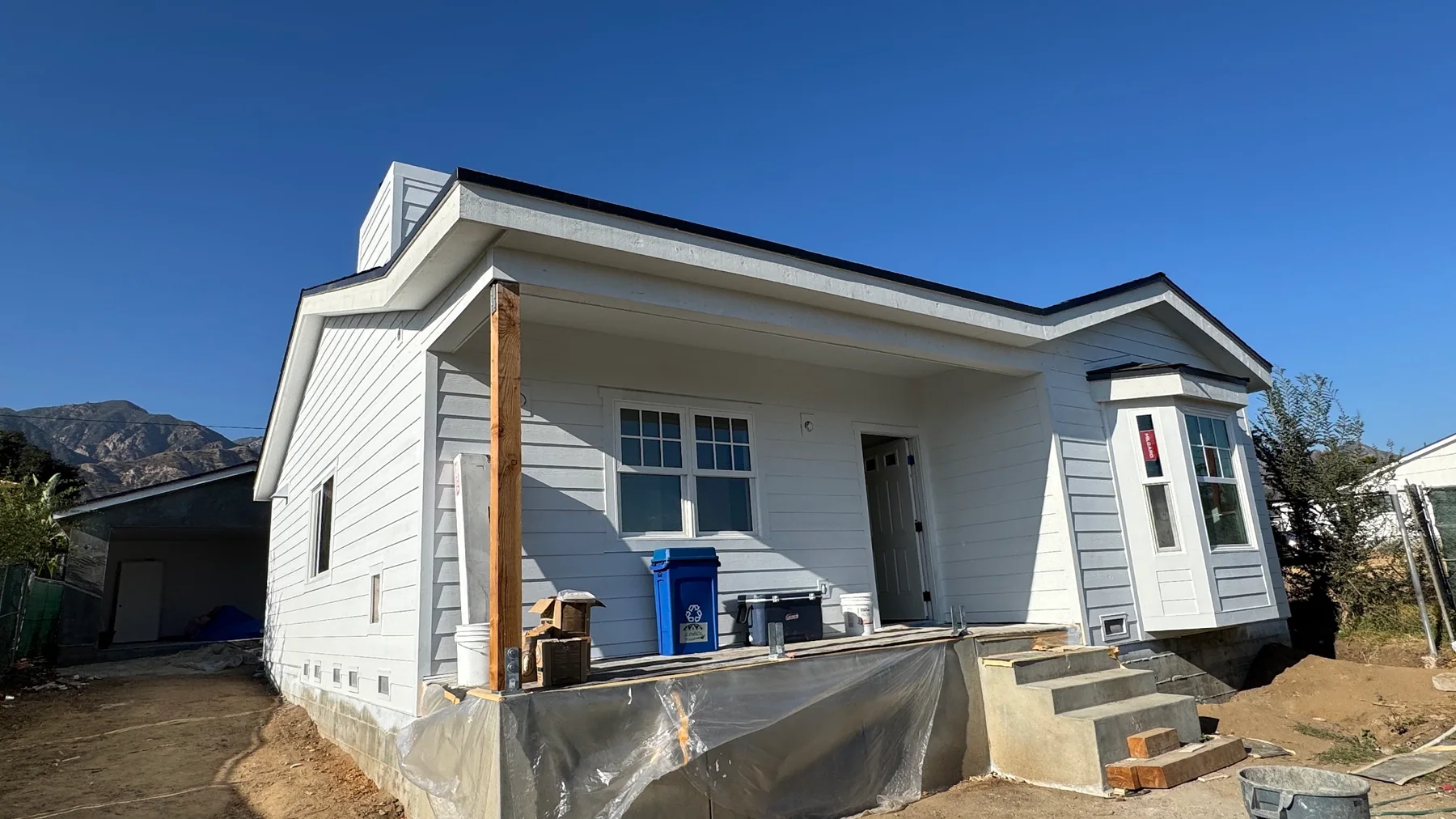 Residential exterior construction progressing on an active jobsite