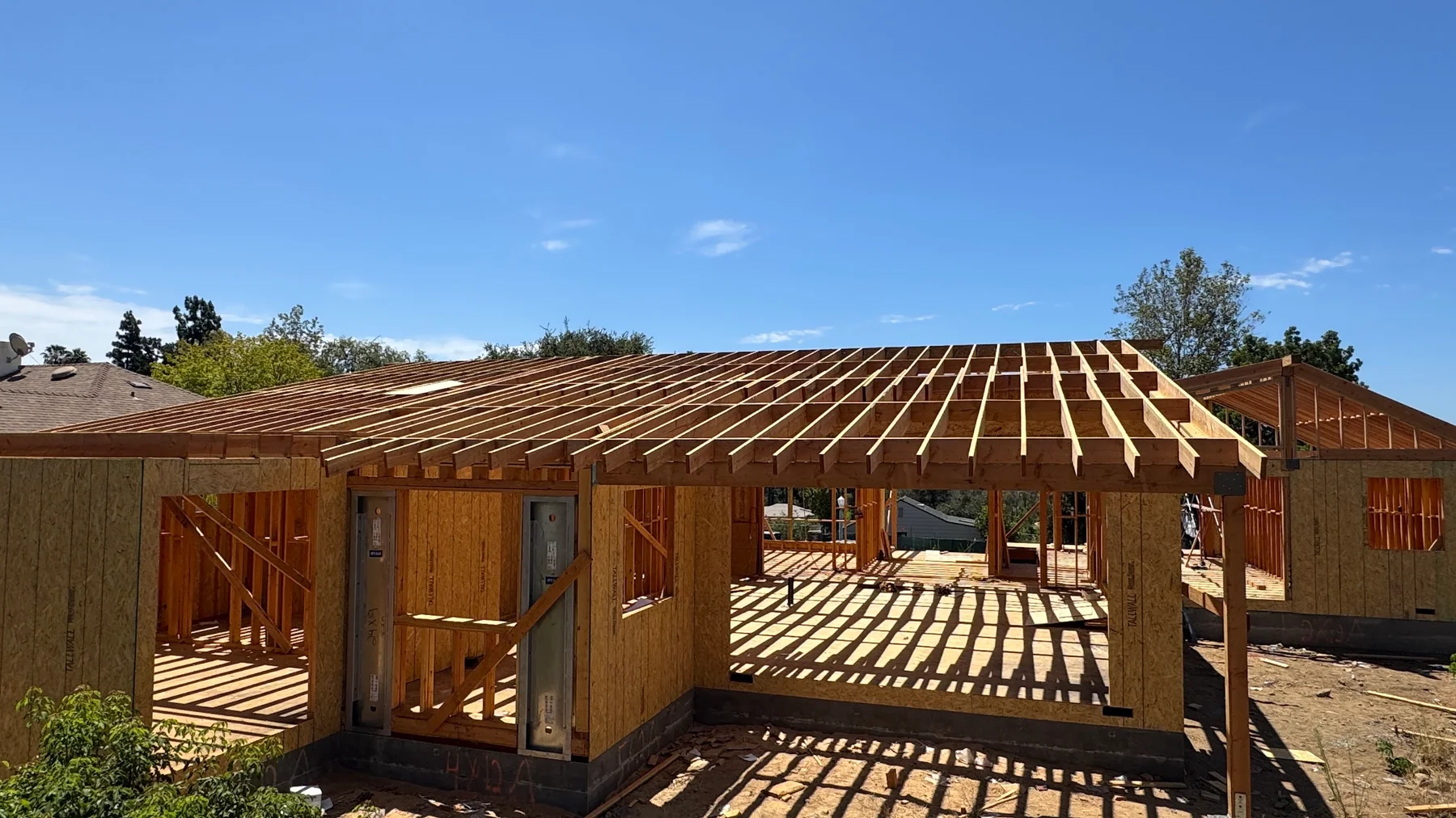 Residential framing underway on an active construction site